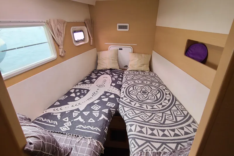 Slide: The Image of Cozy bedroom in 2010 Lagoon 400 owner's version catamaran with patterned bedding. - 41