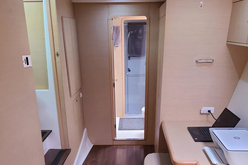 Slide: The Image of Interior of 2010 Lagoon 400 owner's version catamaran with modern furnishings and workspace. - 47