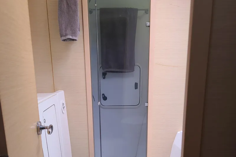 Slide: The Image of Bathroom interior of 2010 Lagoon 400 owner's version with shower and towel. - 48