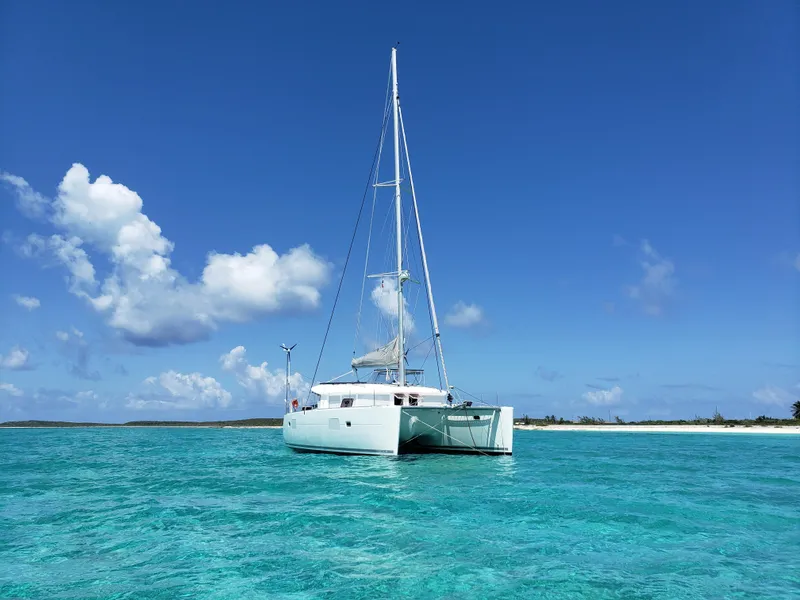 Slide: The Image of Lagoon 400 owner's version catamaran sailing in clear turquoise waters, 2010 model. - 6
