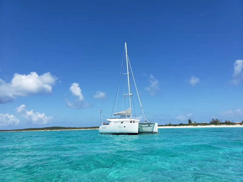 Slide: The Image of Lagoon 400 catamaran anchored in clear turquoise waters, 2010 model. - 7