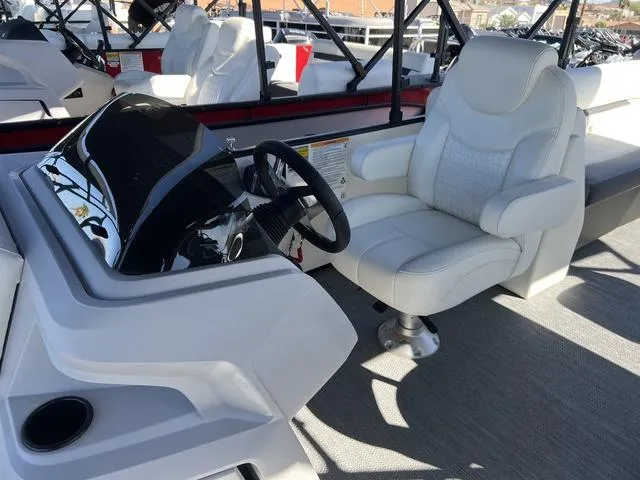 Slide: The Image of 2024 Godfrey Pontoons SW2486MT helm with captain's chair and steering wheel. - 6