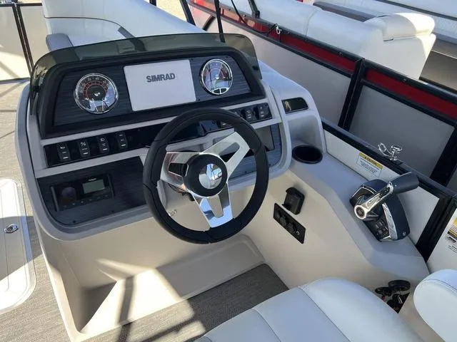 Slide: The Image of 2024 Godfrey Pontoons SW2486MT helm with steering wheel and control panel. - 7