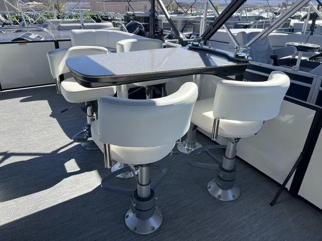 Slide: The Image of 2024 Godfrey Pontoons SW2486MT interior with dining table and swivel chairs - 9