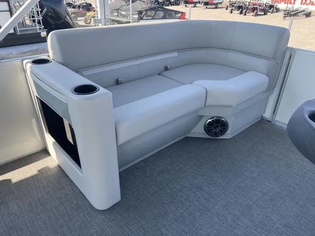 Slide: The Image of 2025 Godfrey Pontoons EX2286SBX boat interior with gray seating and cup holders. - 10