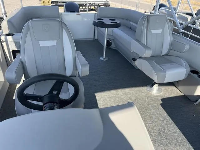 Slide: The Image of 2025 Godfrey Pontoons EX2286SBX interior, featuring plush seating and modern steering wheel. - 5