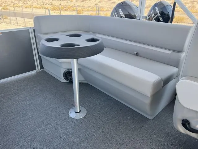 Slide: The Image of Interior seating of 2025 Godfrey Pontoons EX2286SBX with cup holder table. - 9