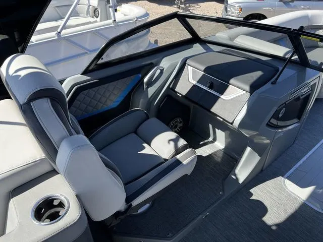 Slide: The Image of 2023 Godfrey Pontoons AquaPatio 256 SBW Twin helm station with luxurious seating and modern controls. - 10