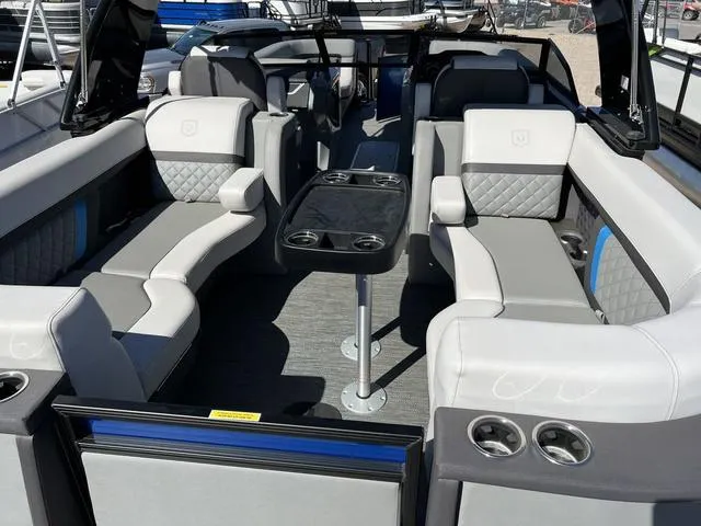 Slide: The Image of 2023 Godfrey Pontoons AquaPatio 256 SBW Twin interior with luxurious seating and table. - 11