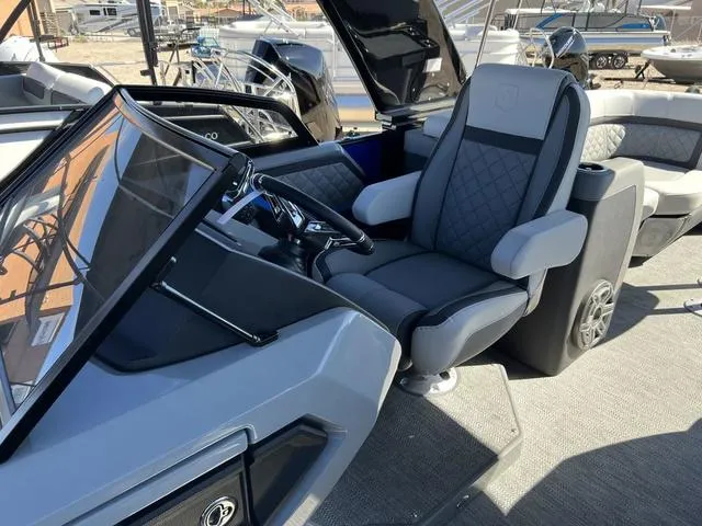 Slide: The Image of 2023 Godfrey Pontoons AquaPatio 256 SBW Twin helm seat and dashboard. - 7