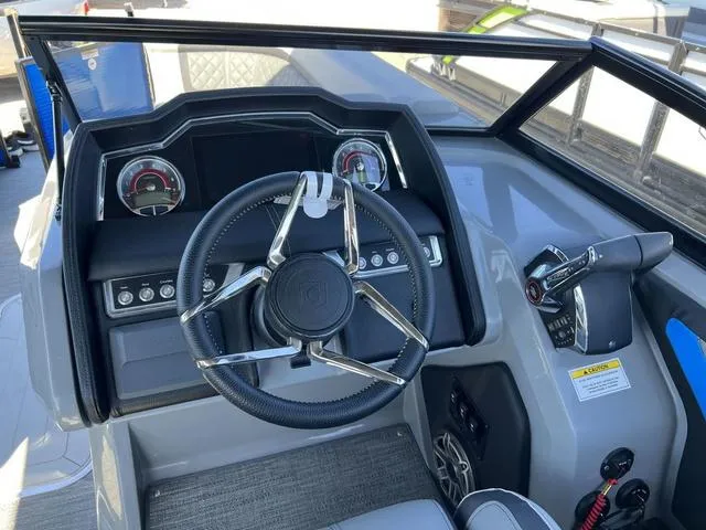 Slide: The Image of 2023 Godfrey Pontoons AquaPatio 256 SBW Twin helm with steering wheel and controls. - 9
