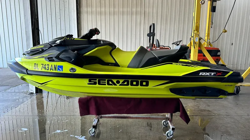Slide: The Image of 2018 Sea-Doo RXT-X 300 jet ski in bright yellow, displayed indoors on a stand. - 5