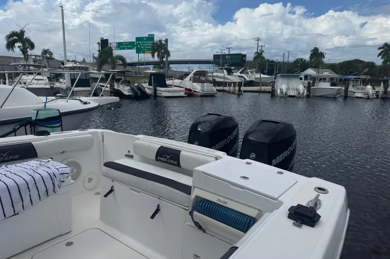Slide: The Image of 2004 Pro-Line 30 Express Walkaround boat interior at a marina. - 36