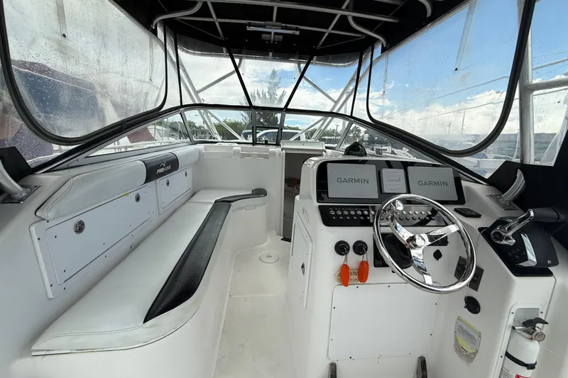 Slide: The Image of 2004 Pro-Line 30 Express Walkaround boat interior with seating and sink. - 39