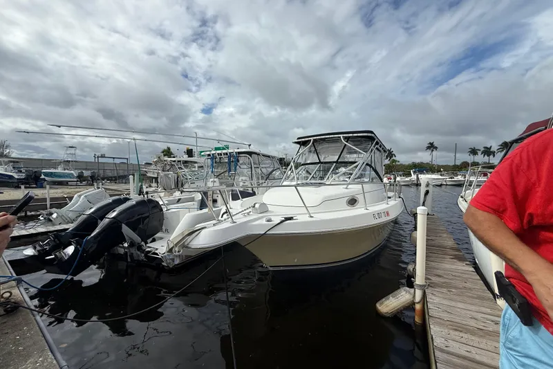 Slide: The Image of 2004 Pro-Line 30 Express Walkaround cabin interior with white cushioned seating and porthole. - 43