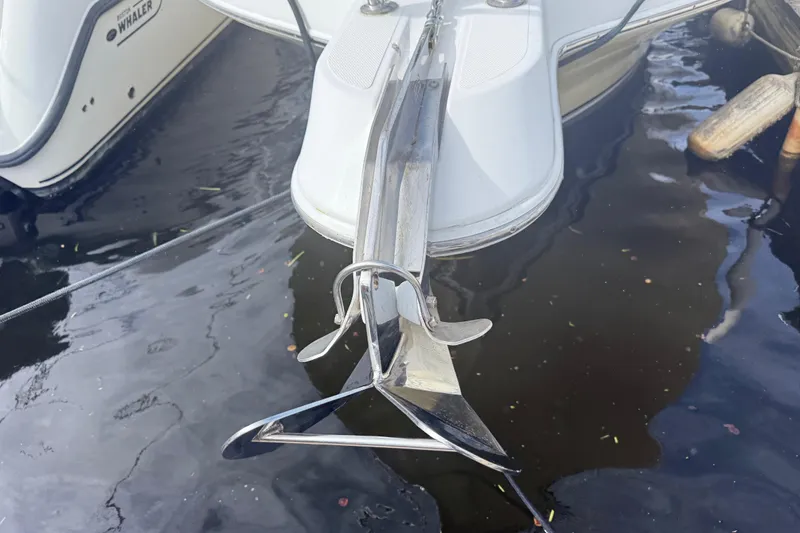 Slide: The Image of 2004 Pro-Line 30 Express Walkaround boat bathroom with toilet, sink, and storage. - 46