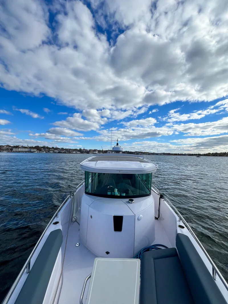 Slide: The Image of 2022 Axopar 28 Cabin Aft Cabin boat on open water under cloudy sky. - 32
