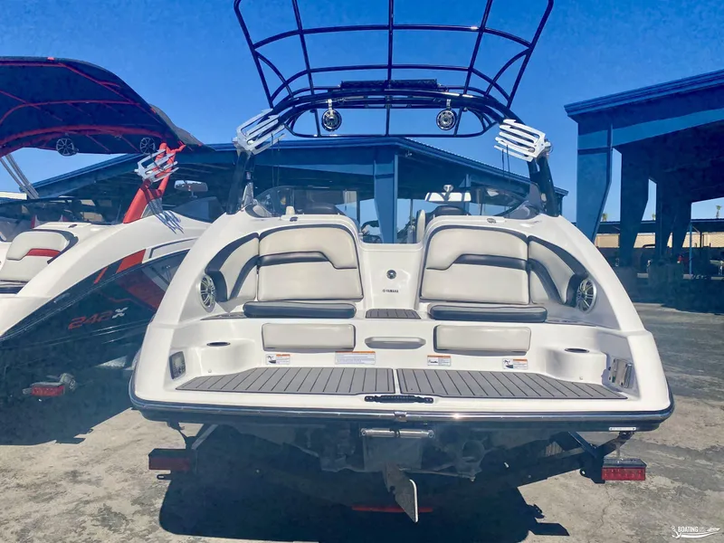 Slide: The Image of 2017 Yamaha Boats 242X, rear view, docked with another boat. - 3