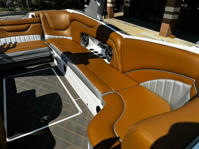 Slide: The Image of 2023 MB SPORTS B52 23 Alpha boat interior with brown and silver seating. - 12