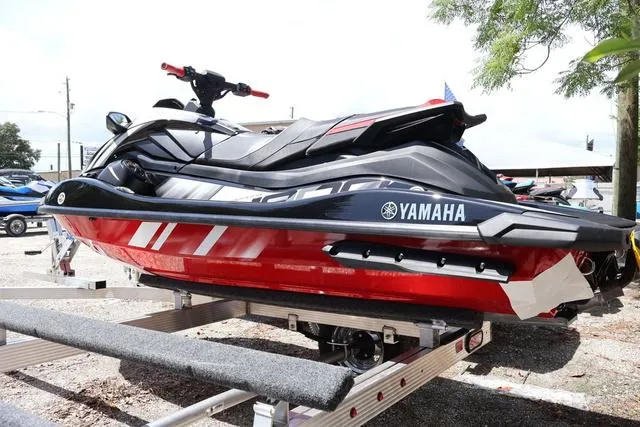 Slide: The Image of 2024 Yamaha Marine Waverunner GP HO with audio, black and torch red design on trailer. - 3