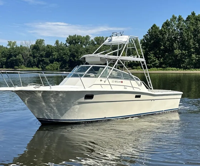 Slide: The Image of 1984 Aquasport 270 Express Fisherman boat on calm water. - 2