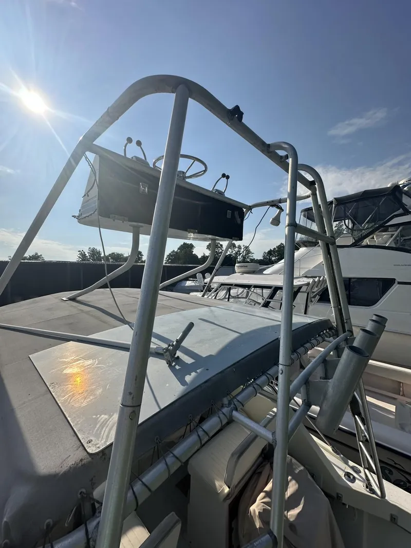 Slide: The Image of 1984 Aquasport 270 Express Fisherman boat with a sturdy frame and clear sky background. - 22