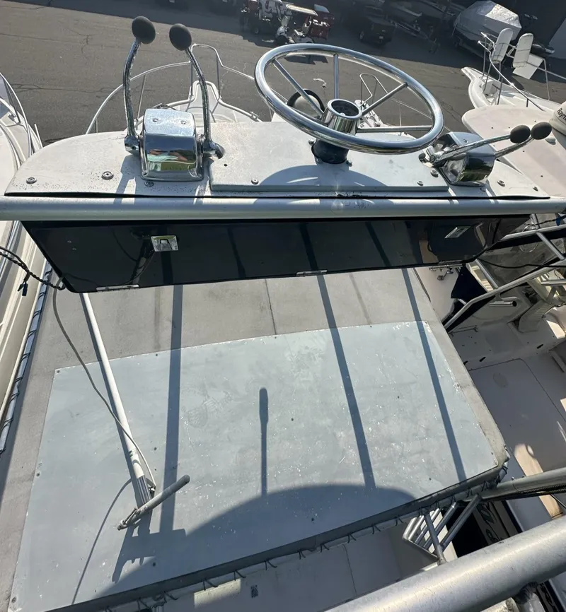 Slide: The Image of 1984 Aquasport 270 Express Fisherman boat helm with steering wheel and controls. - 23