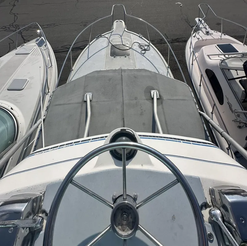 Slide: The Image of 1984 Aquasport 270 Express Fisherman boat docked, top view of the deck and steering wheel. - 24