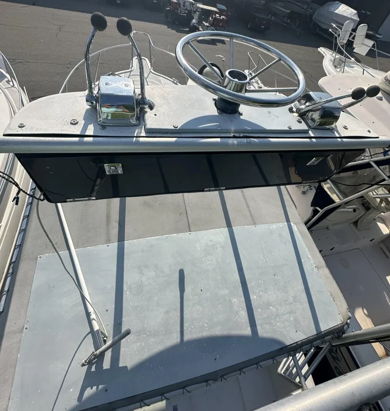 Slide: The Image of 1984 Aquasport 270 Express Fisherman boat helm with steering wheel and controls. - 25