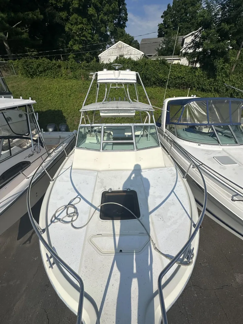 Slide: The Image of 1984 Aquasport 270 Express Fisherman boat docked, top view. - 27