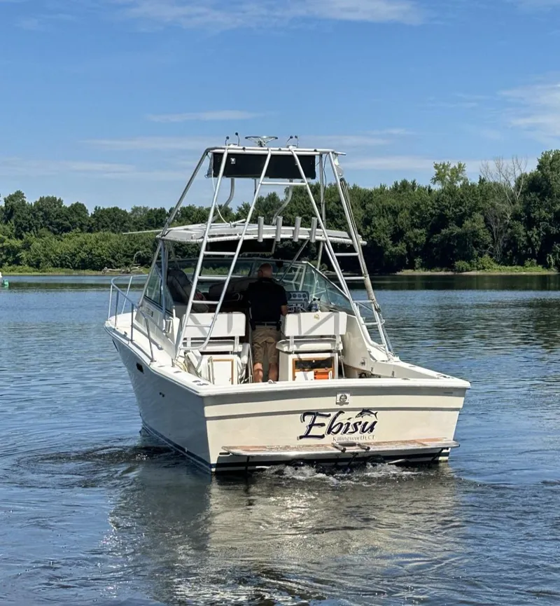 Slide: The Image of 1984 Aquasport 270 Express Fisherman boat on a calm lake. - 3
