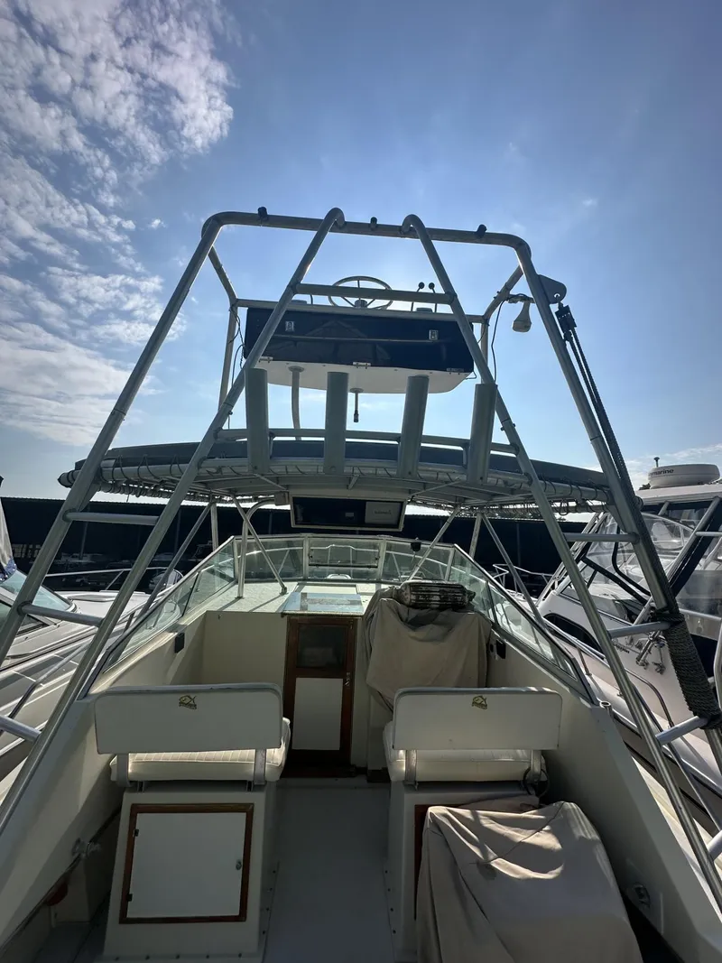 Slide: The Image of 1984 Aquasport 270 Express Fisherman boat with upper deck and seating area. - 6