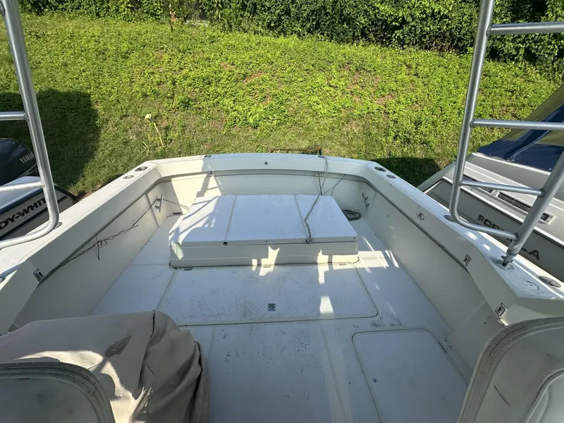 Slide: The Image of 1984 Aquasport 270 Express Fisherman boat deck with storage compartments. - 8