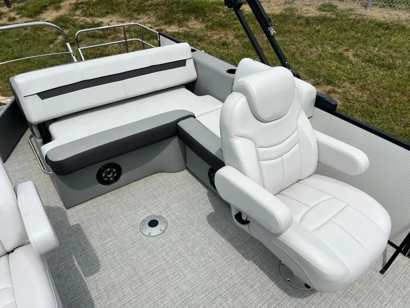 Slide: The Image of 2023 Godfrey SWEETWATER 2286 SFL boat interior with white seating and captain's chair. - 10