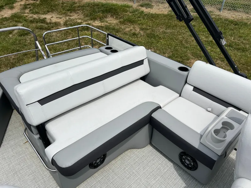 Slide: The Image of 2023 Godfrey SWEETWATER 2286 SFL boat seating area with cup holders and speakers. - 11