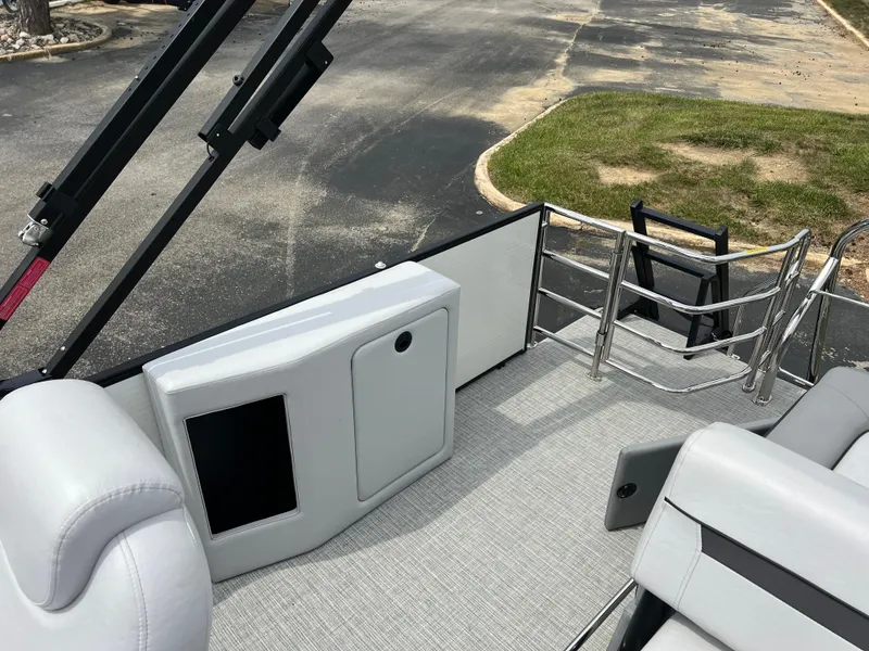 Slide: The Image of 2023 Godfrey SWEETWATER 2286 SFL boat interior with seating and ladder. - 12