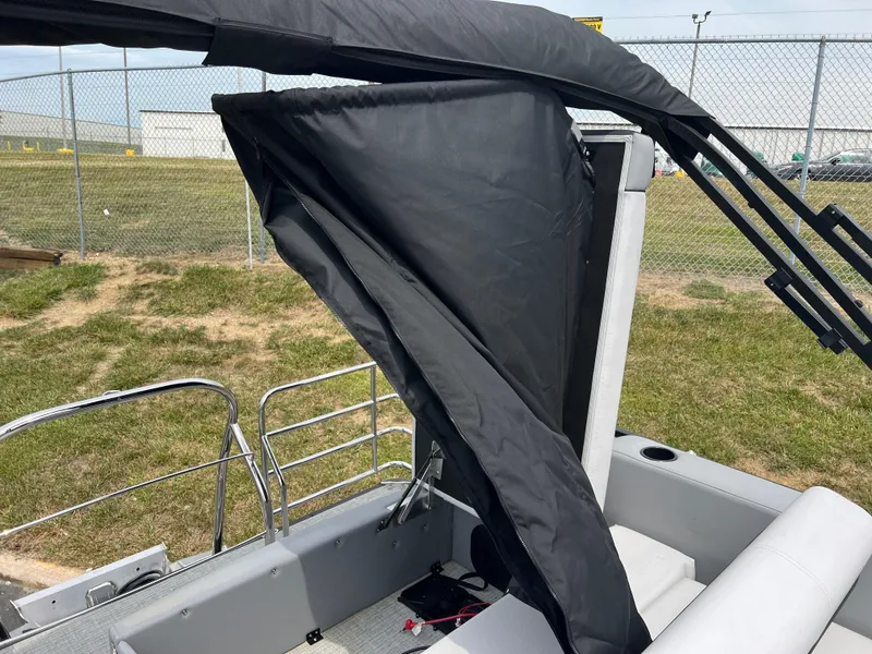 Slide: The Image of 2023 Godfrey SWEETWATER 2286 SFL boat with partially folded black canopy. - 14