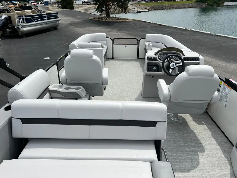 Slide: The Image of 2023 Godfrey SWEETWATER 2286 SFL pontoon boat interior with white seating and steering console. - 16