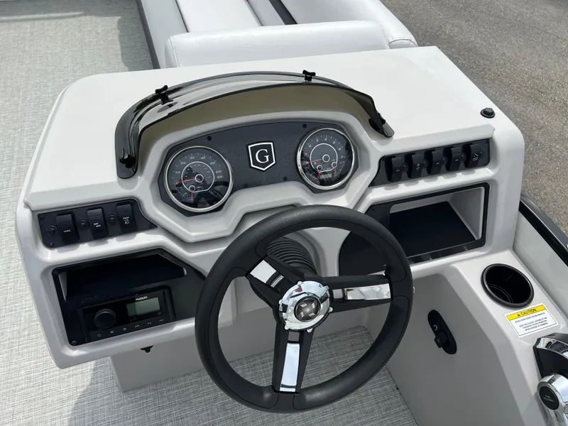 Slide: The Image of 2023 Godfrey SWEETWATER 2286 SFL boat dashboard with steering wheel and instrument panel. - 18