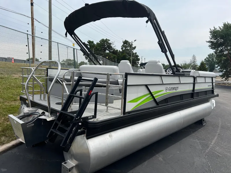 Slide: The Image of 2023 Godfrey SWEETWATER 2286 SFL pontoon boat with black canopy and green accents. - 3