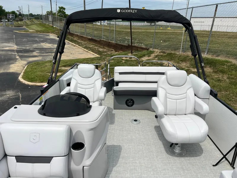 Slide: The Image of 2023 Godfrey SWEETWATER 2286 SFL pontoon boat interior with white seating and black canopy. - 9
