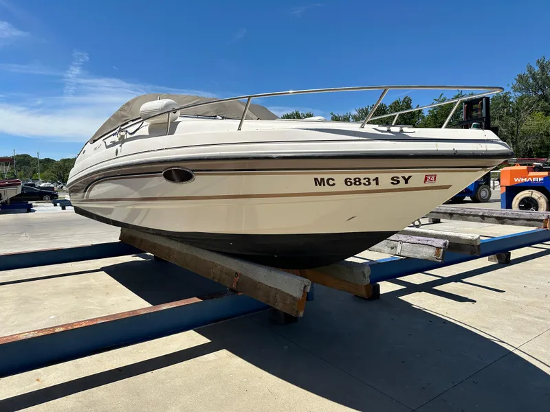 The Image of 1998 Chaparral 2335 SS boat on a trailer under clear blue sky. - 0