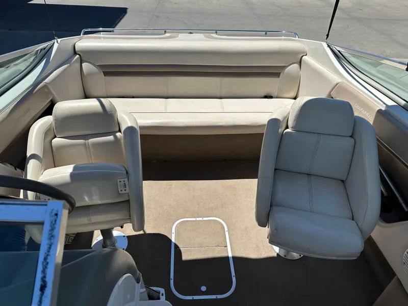 Slide: The Image of 1998 Chaparral 2335 SS boat interior with beige seating and carpet. - 10