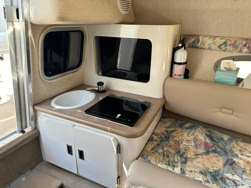 Slide: The Image of 1998 Chaparral 2335 SS boat interior with kitchenette and seating area. - 12