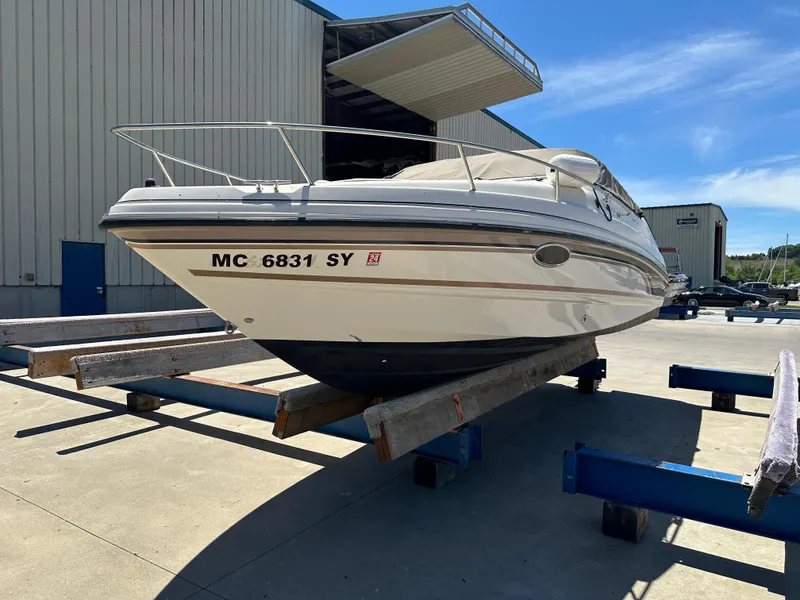 Slide: The Image of 1998 Chaparral 2335 SS boat on a dry dock outside a warehouse. - 2