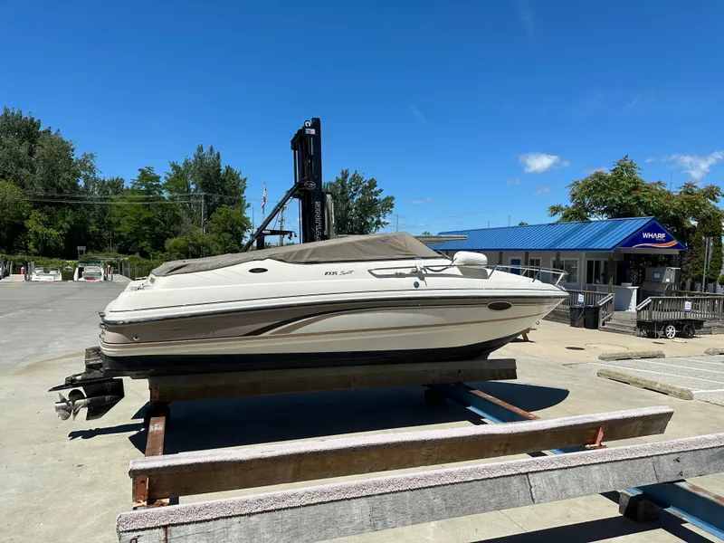 Slide: The Image of 1998 Chaparral 2335 SS boat on a dock under a clear blue sky. - 3