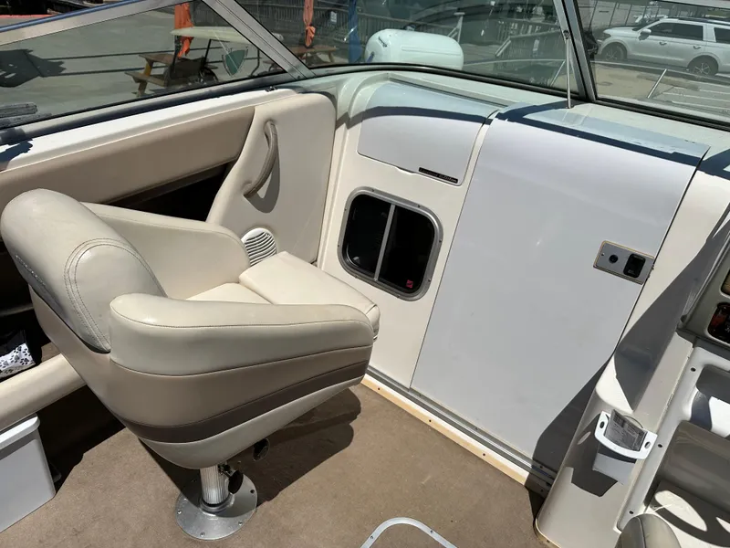 Slide: The Image of 1998 Chaparral 2335 SS boat interior with captain's chair and dashboard. - 6