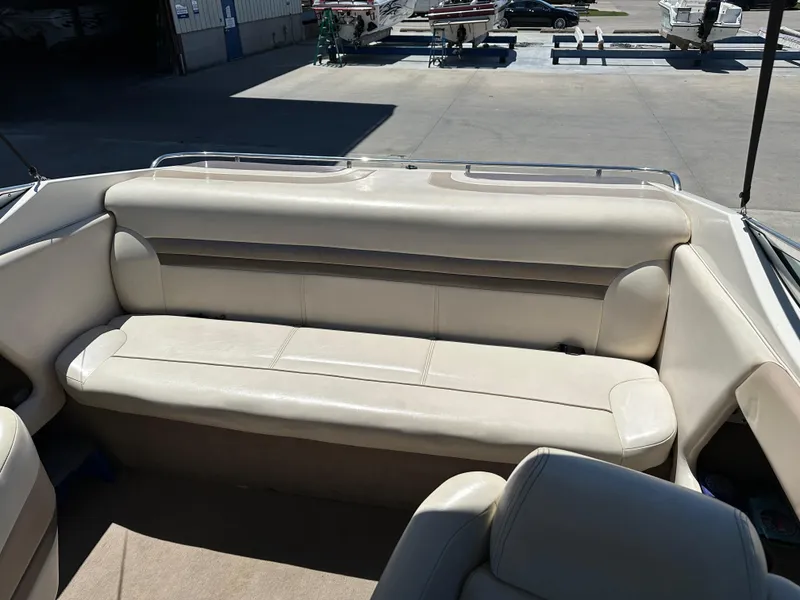 Slide: The Image of 1998 Chaparral 2335 SS boat interior with beige leather seating. - 9