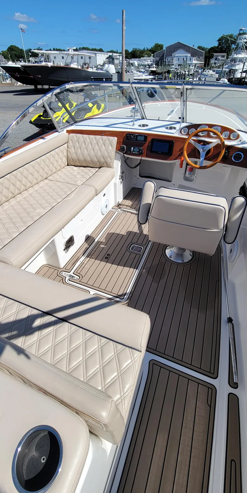 Slide: The Image of 2017 Vanquish Runabout boat interior with beige seating and wooden accents. - 4