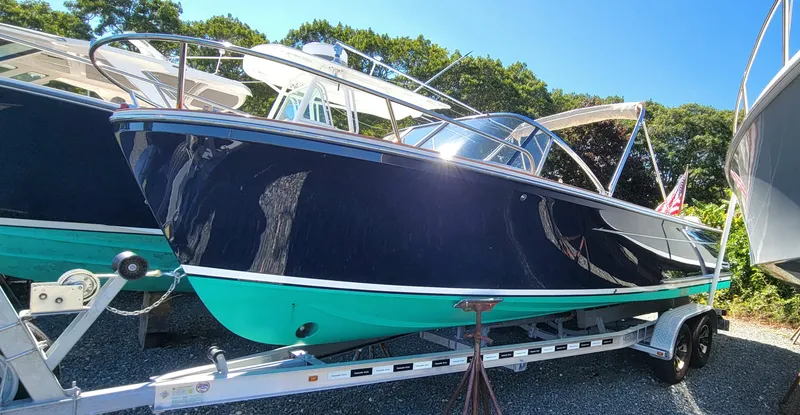 Slide: The Image of 2017 Vanquish Runabout boat on trailer, sleek design, blue and turquoise hull. - 6